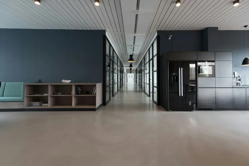 Modern office with employees arriving and checking in at the start of the work day