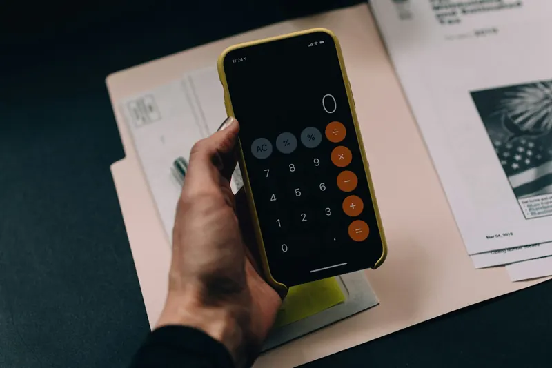 Accountant reviewing financial documents and payroll reports at a clean desk